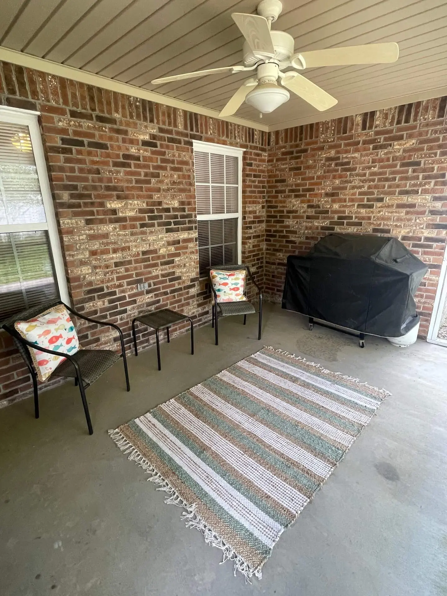 Landmark — covered back patio with grill and seating