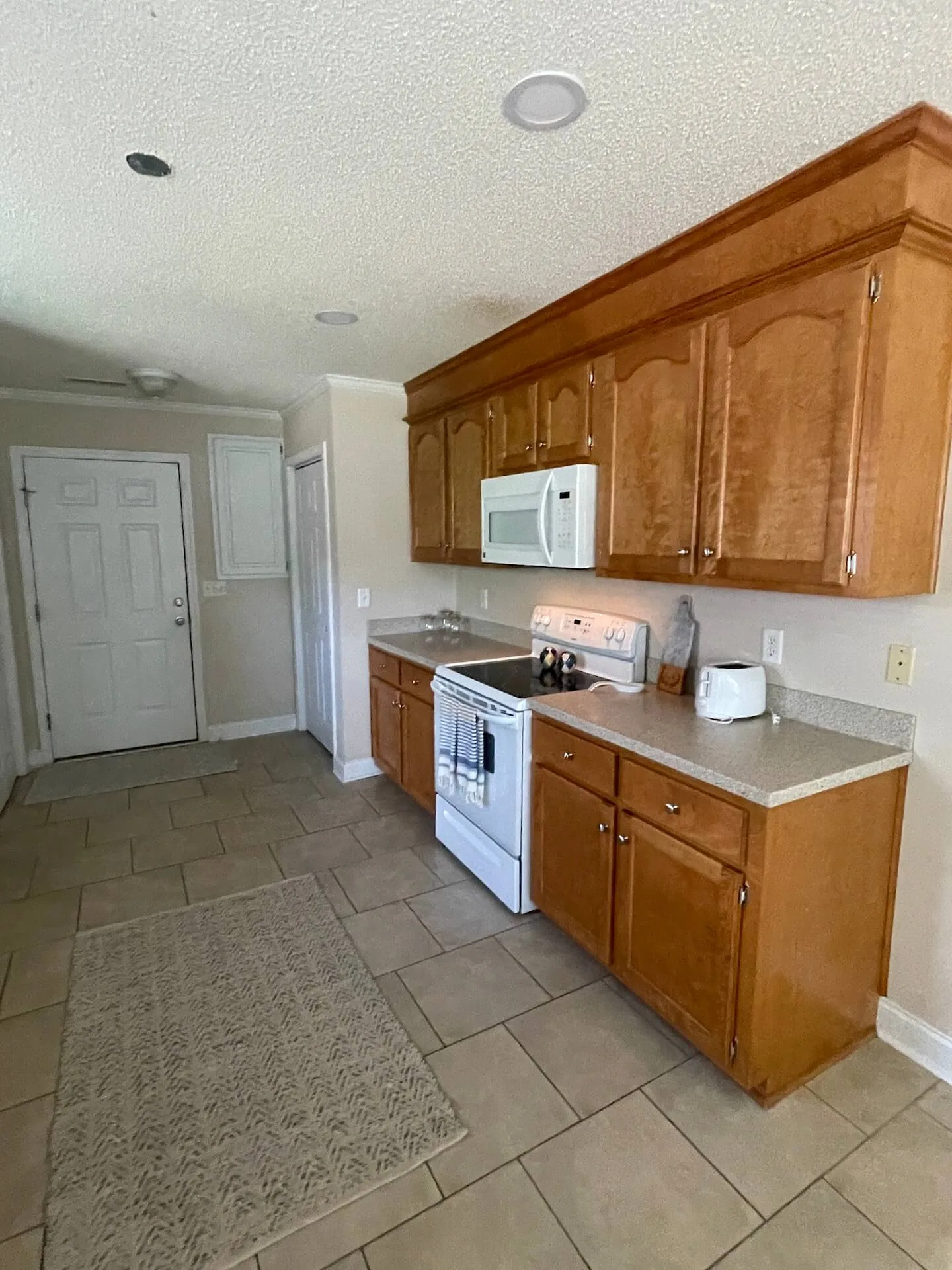 Landmark — kitchen with range and ample cabinetry